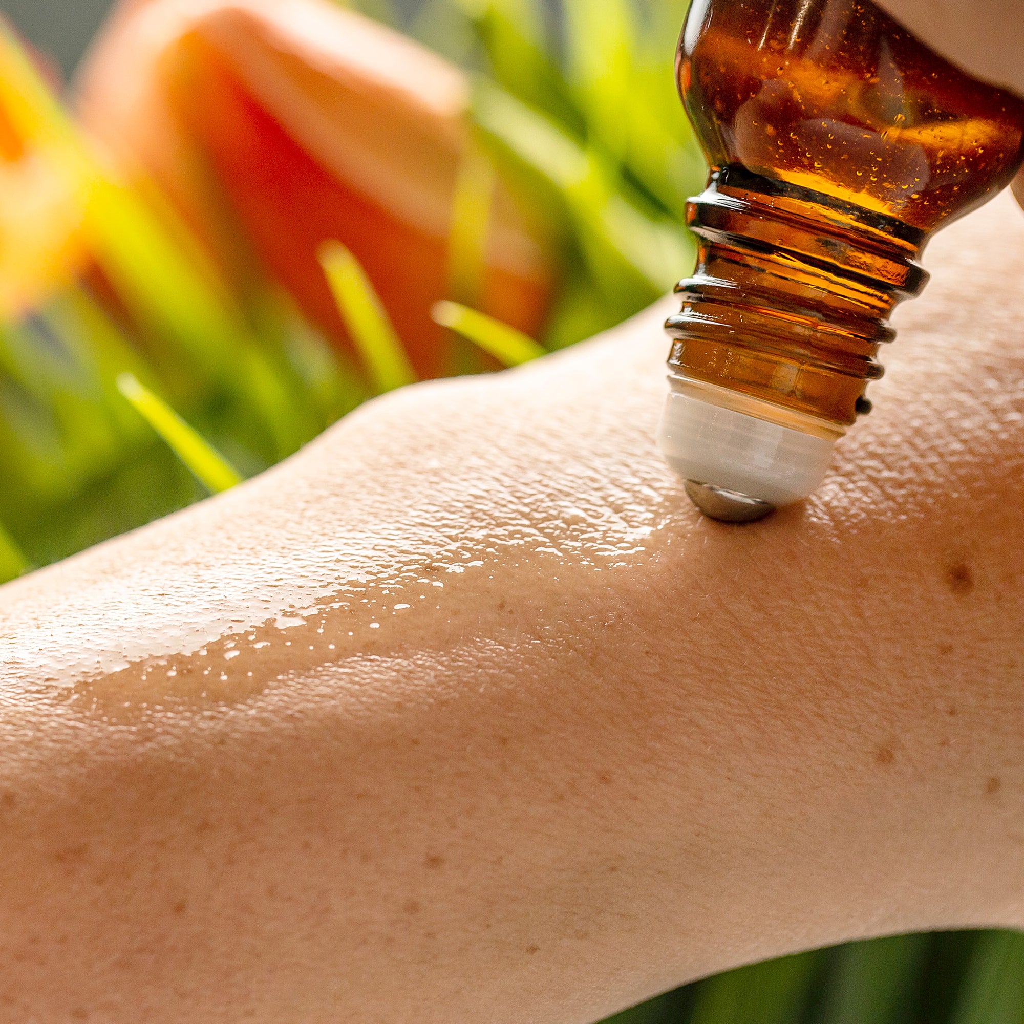 Someone applying essential oils to their wrist from a 15 ml essential oil vial with a SpringLock roller ball.