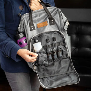 A woman holding up the doTERRA Branded Backpack with the front pocket open displaying essential oil vials, roller bottles, and a larger carrier oil bottle.