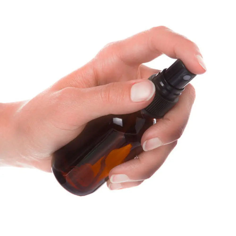 2 Oz. Amber Glass Bottle With Misting Sprayer, black top, hand reference shot