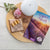 Essential Educators "Diffuser Blends to Live By" booklet with a diffuser, 4 ml roller bottles, and flowers.