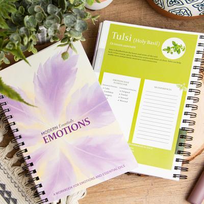 Two copies of the Modern Essentials Emotions book: one showing the cover and the other showcasing its "Tulsi" oil page.