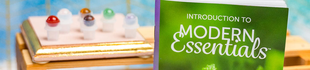 Close up of an "Introduction to Modern Essentials" booklet (11th Edition) with gemstone roller ball inserts.