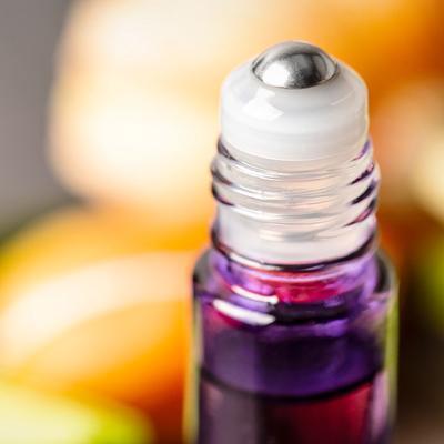 A close up of the leak-proof SpringLock rollerball on a purple roller bottle.