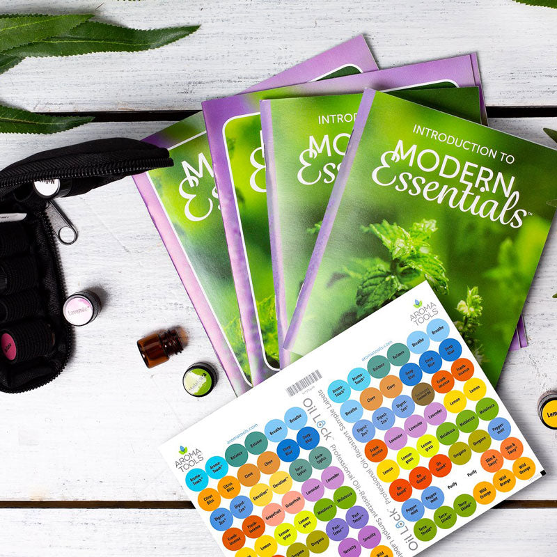 "Introduction to Modern Essentials" booklets and "Simple Solutions" booklets (11th Editions) with Oil Lock sticker labels and sample vials.